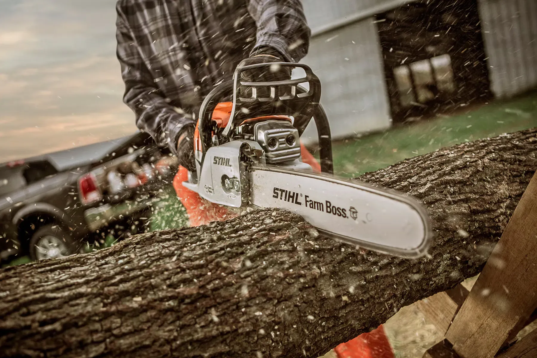 Kiwi farmer using a STIHL chainsaw on a large rural property