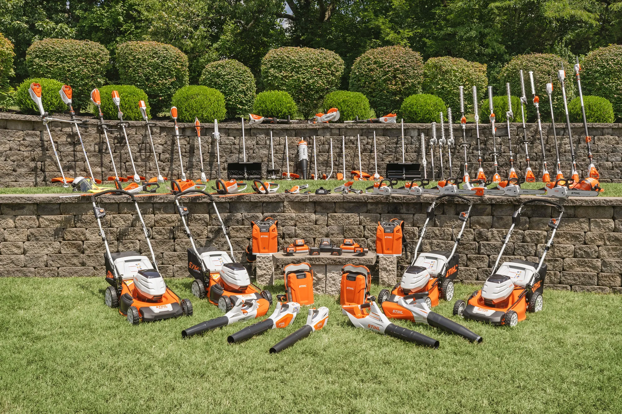 Homeowner using a STIHL battery line trimmer in a garden